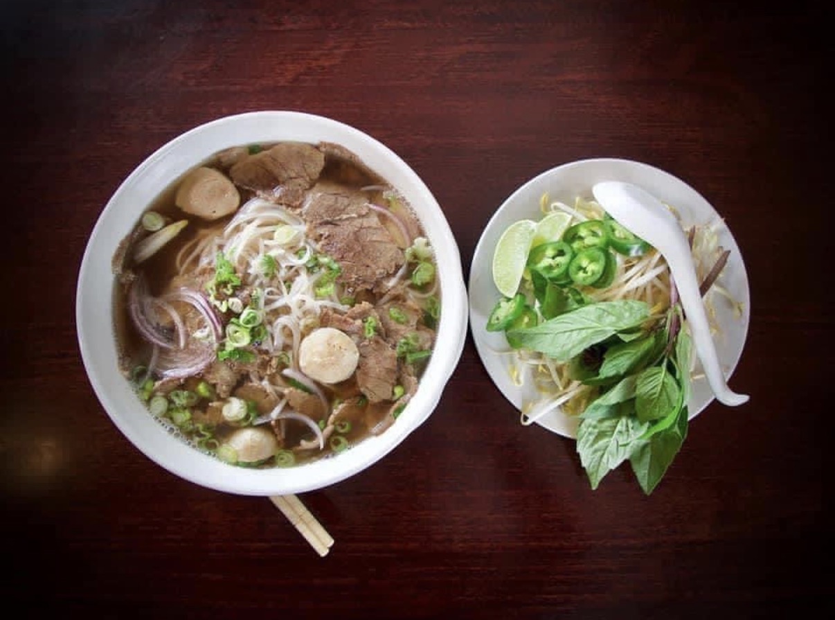 A bowl of pho from Sara Thai with herbs, lime and bean sprouts